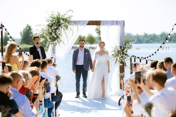 Fototapeta premium wedding ceremony on a high pier near the river