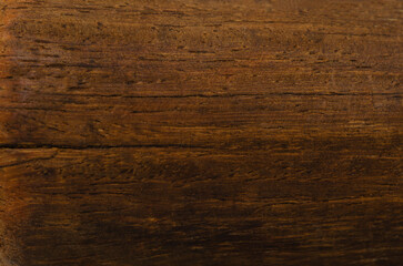 Old grunge wooden cutting kitchen desk board as background, copy space available. Dark scratched grunge cutting board