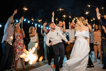 newlyweds at a wedding of sparklers