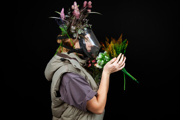 A portrait of a lonely sad girl breathing with a gas mask with a leaves and plants attached to it,...