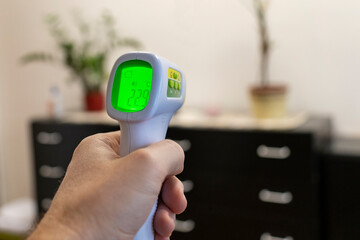 Hand holding an electronic thermometer