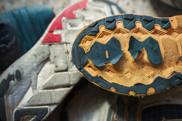  Worn soles of a running shoes, from which the excess supination can be recognized. It causes...