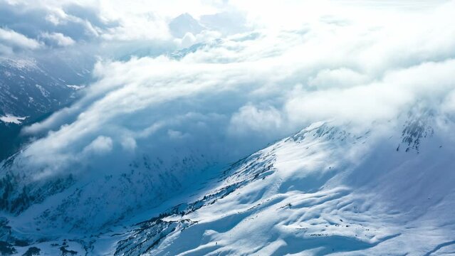 Aerial time lapse of the mountains in the luxury ski resort St. Anton in Austria during sunny winter day.