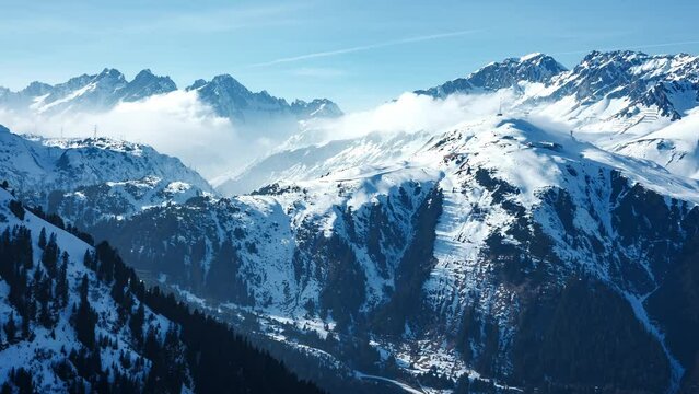 Aerial time lapse of the mountains in the luxury ski resort St. Anton in Austria during sunny winter day.