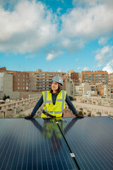 Confident caucasian Female electrician engineer portrait, in yellow vest working solar panel renewable energy, photovoltaic cells, power station provides supply power to urban house. Vertical