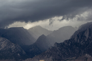 Sun beams shine down on the Sierra Nevada Mountains in California. view from the Alabama hills looking towards Whitney Portal