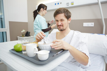 disgusted patient having breakfast in hospital