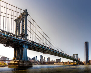 Brooklyn, USA - April 28, 2022: View of Manhattan bridge from Dumbo district in Brooklyn. Skyline of Manhattan in background