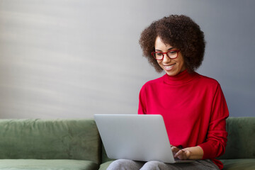 Smiling woman freelancer, copywriter typing on keyboard, using laptop working online from home....