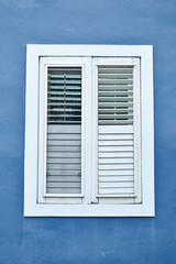 White window frames on a blue wall