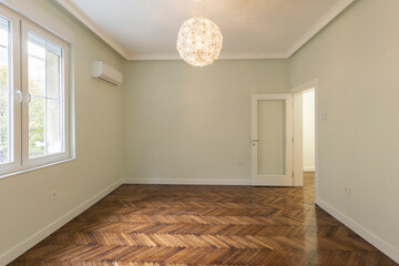 Interior of an empty apartment with brown wooden parquet