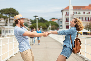 romantic happy couple having fun dancing on beach pier