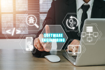 Software engineering concept, Businessman working on laptop computer and hand touching software engineering icon on virtual screen.