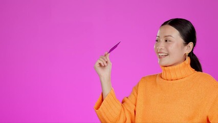 Payment, pos and asian woman with credit card on pink background with technology, shopping and smile. Ecommerce, logistics and customer paying for delivery with tap transaction isolated in studio.