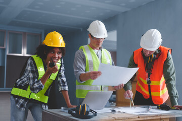 Fototapeta premium Group of multi ethnic engineer construction site worker meeting at workplace, Architects working together at construction site to remodeling home or building.