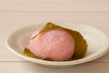 Japanese sweets in spring. Sakura mochi on white table. 春の和菓子。白いテーブルの上の桜餅