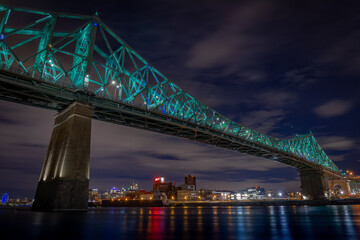 Fototapeta na wymiar Montreal, the Jacques Cartier Bridge was the first in the world to be connected, it presents a light show by Moment Factory.