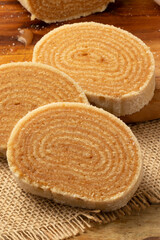 Focus on sliced roll cake of dulce de leche.
