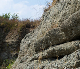 Black Sea coast. A seashore formed by frozen volcanic lava. Tectonic rocks.