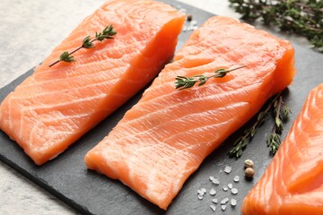 Fresh raw salmon and ingredients for marinade on slate board, closeup