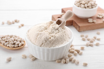 Fototapeta na wymiar Kidney bean flour and seeds on white wooden table