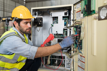 Male electrician worker checking, repair, maintenance operation electric system in factory. Male...