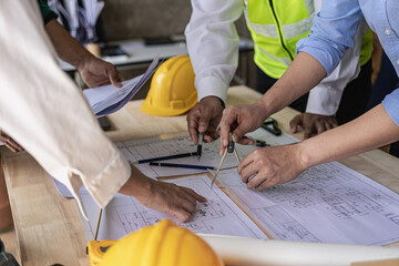 Engineers work as a team with blueprints for architectural plans. Engineer sketching construction project concept with architect equipment Architect and foreman talking at table
