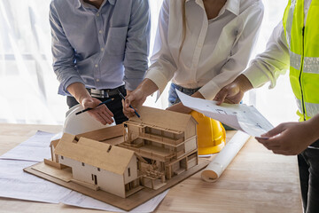 Engineers work as a team with blueprints for architectural plans. Engineer sketching construction project concept with architect equipment Architect and foreman talking at table