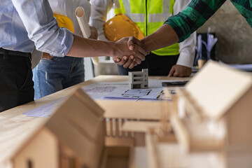 Engineers work as a team with blueprints for architectural plans. Engineer sketching construction project concept with architect equipment Architect and foreman talking at table