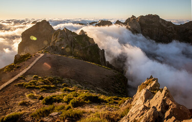 Mountain pinnacles at sunset. Clouds below the peaks.