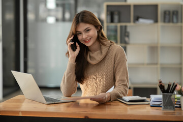 Asian businesswoman working on documents at office