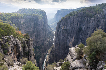 Mountain gorge and a little blue stream flowing between the rocks