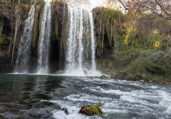 Waterfall falling into a small pond in the forest