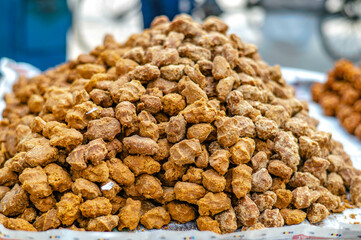 Sugar from sugar cane piles up on a street vendor cart in Sarnath, India.