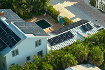 Aerial view of big expensive american building roof with solar photovoltaic panels for producing clean ecological electric energy. Investing in renewable electricity for retirement income concept