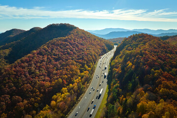 I-40 freeway road leading to Asheville in North Carolina over Appalachian mountain pass with yellow...