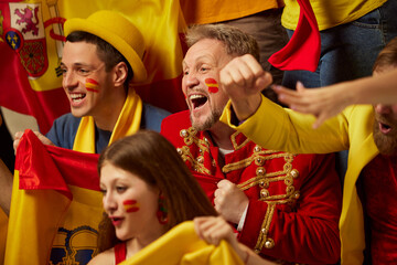 Live game. People, football, soccer fans emotionally watching match, cheering up favourite team. Fans wearing colorful scarves and flags. Concept of sport, cup, world, team, event, competition