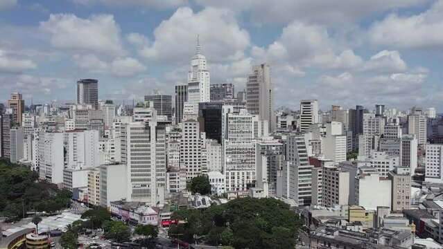 Aerial view around a dense cityscape of tall buildings in sunny Sao Paulo, Brazil
