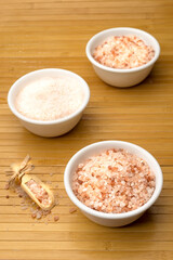 White bowls with coarse and fine Himalayan salt.