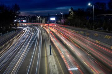 Blurred lights of cars on the highway in the night city