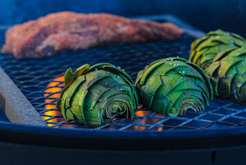 Artichokes with Tri-Tip grilled on a grate over a an open fire