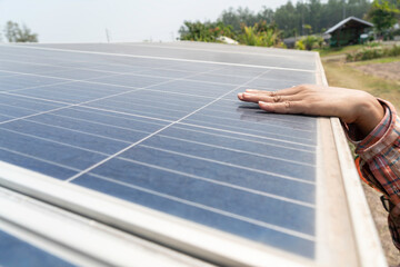 Gardener's hand holding a solar panel.