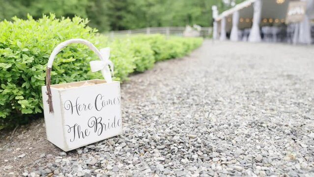 Vintage wedding decoration. Old style basket to decorate a wedding. Here comes the bride. Slow motion.