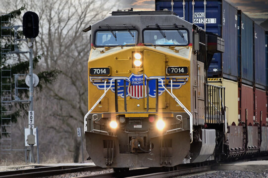 A single Union Pacific Railroad locomotive leads an intermodal freight train through a rural section of northeastern Illinois on its journey to Chicago.