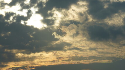 The beautiful sunset sky view with the colorful clouds and warm lights in the sky