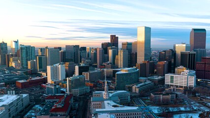Downtown Denver skyline glowing at sunset - Golden Triangle aerial hyperlapse