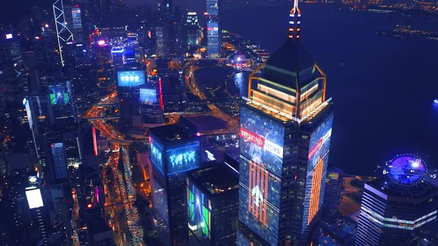 Aerial view of digital city with skyscraper and lighting advertising panels at night in Hong Kong City - Futuristic concept with motion graphic and digital animation - Information data communication