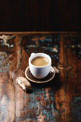 Cup of coffee and Cantuccini (Italian cookie) on dark wooden background. Copy space.