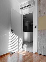 Open white door in light room
