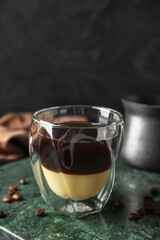 Glass of tasty Cafe Bombon on dark background, closeup
